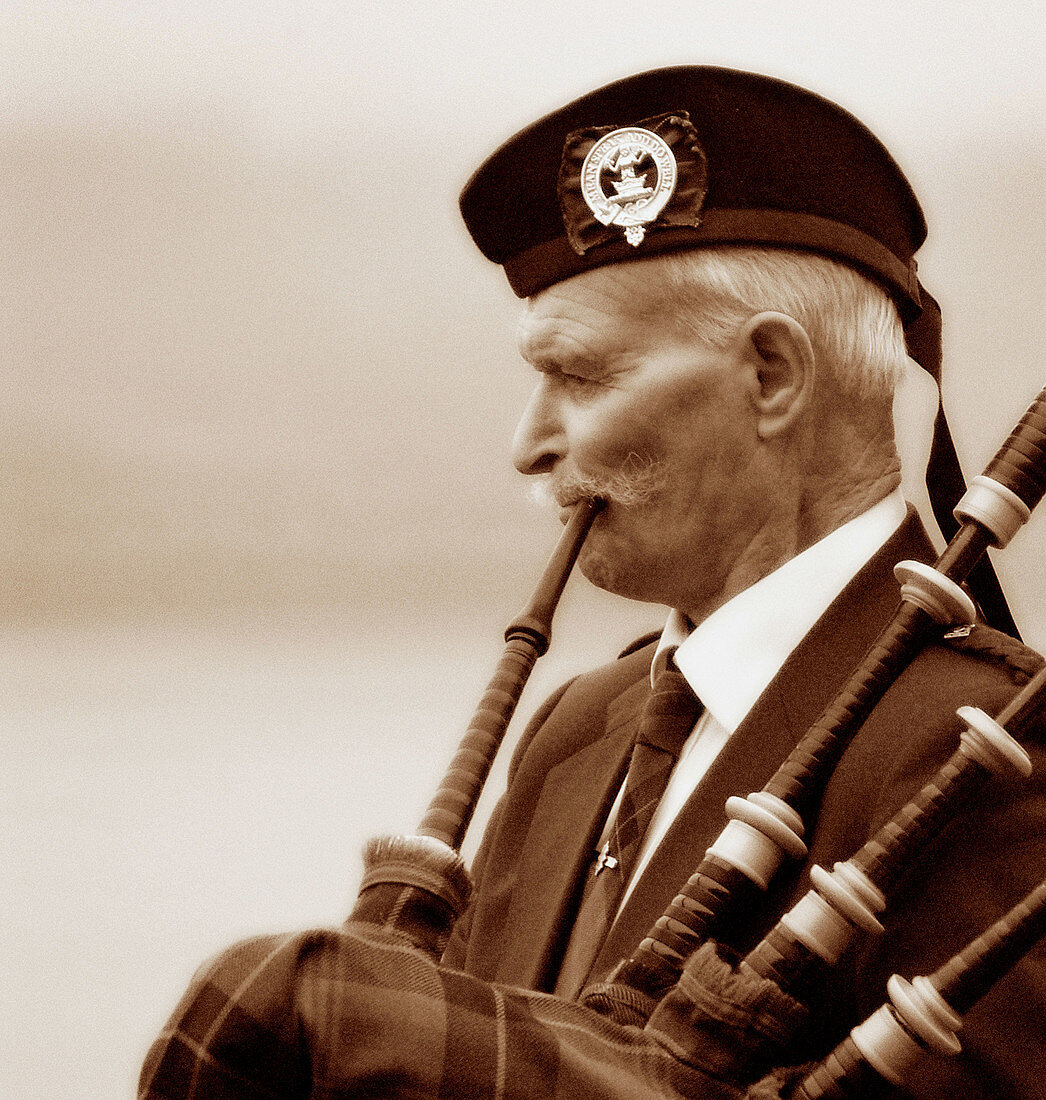 Pipe musician at Loch Ness. Scotland. Great Britain. UK.