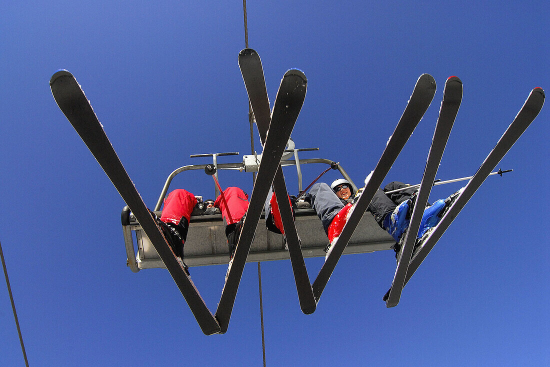 Skiers on chairlift. La Molina ski resort. Cerdanya. Girona. Catalonia, Spain