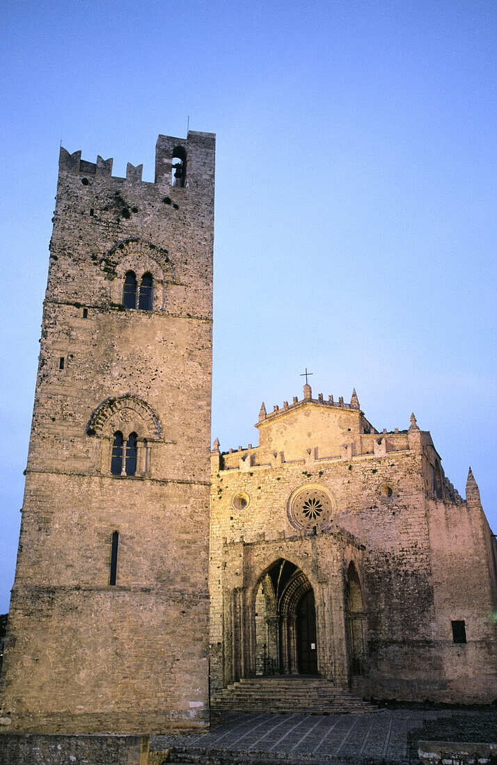Italy. Sicily. Erice. Medieval bell tower and church in twilight.