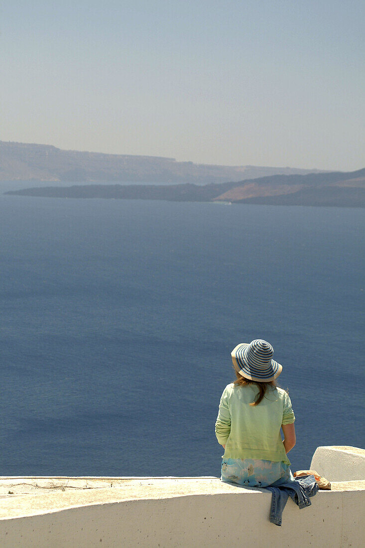 Santorini, Greece, a tourist in the village of Oia.