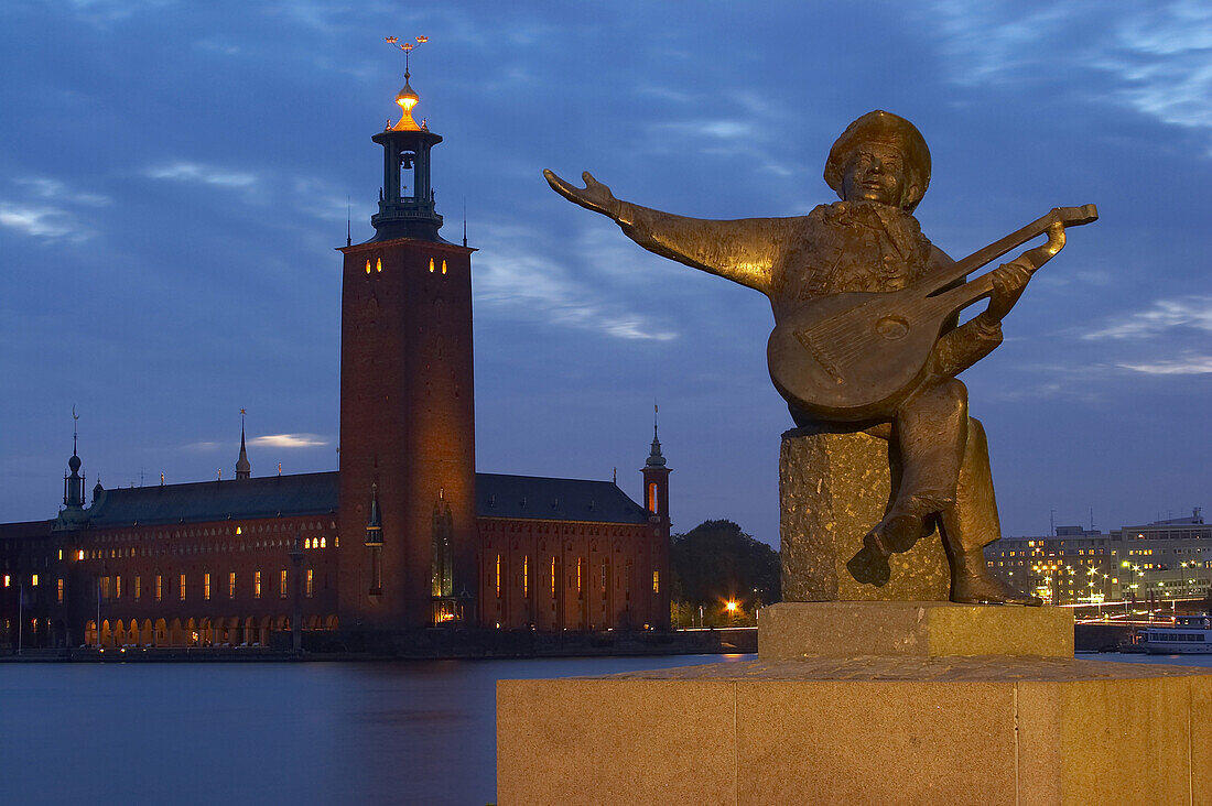 Sculpture of a musician on Riddarholmen and view onto the Stadshuset on Kungsholmen, Stockholm, Sweden