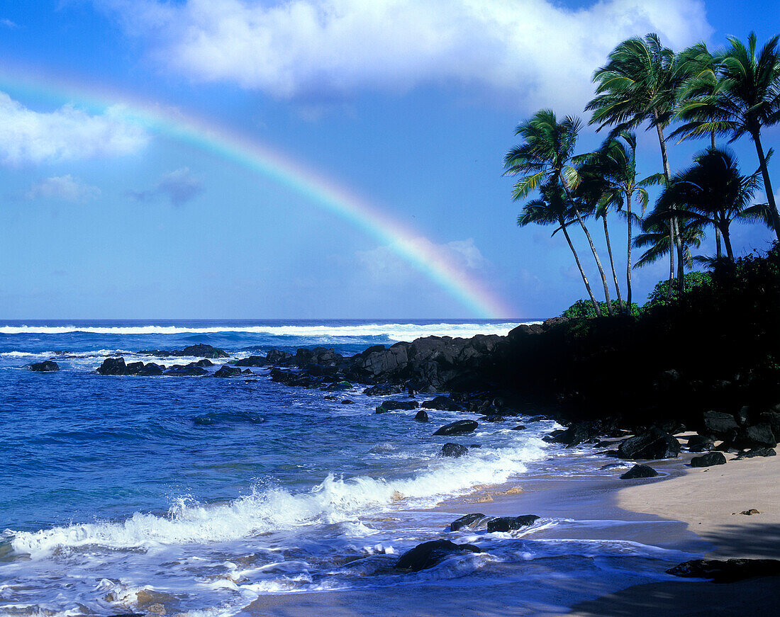 Scenic rainbow on beach, North shore coastline, oahu, hawaii, USA.