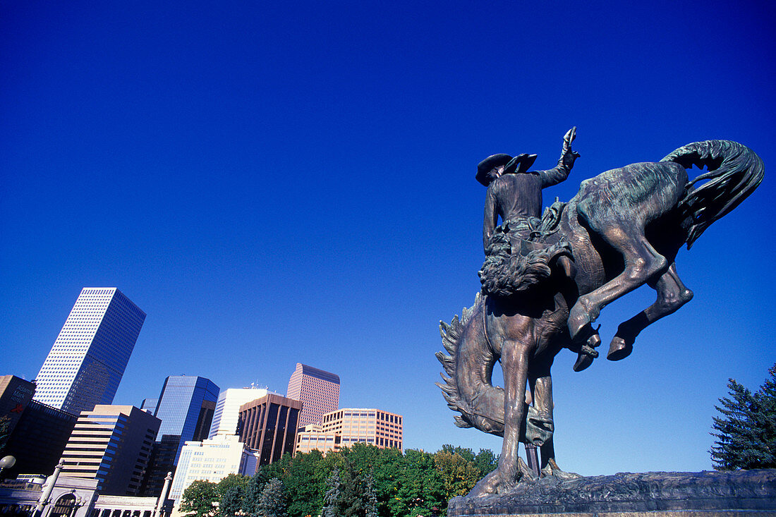 Cowboy statue, Civic center &downtown skyline, Denver, Colorado, USA.