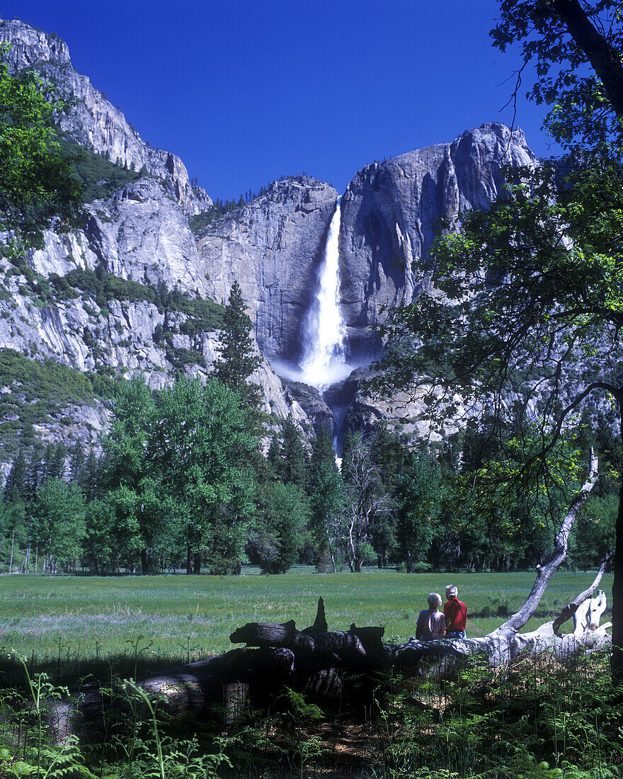 Couple, Scenic upper yosemite waterfall, Merced river, Yosemite nationalpark, California, USA.