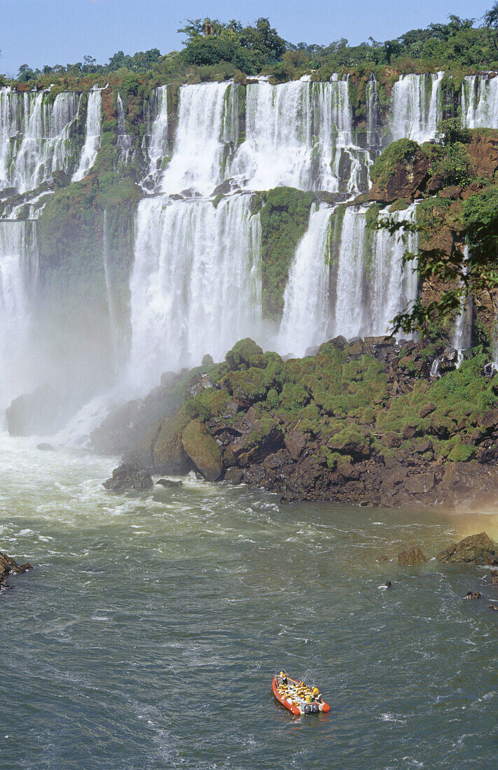 Rubber dinghies getting closer to the falls. Iguazu National Park. Misiones province. Argentina.