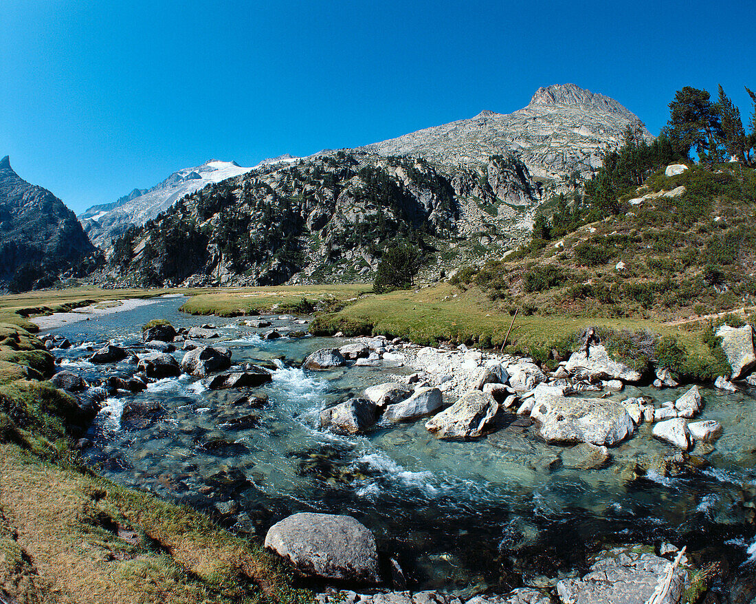 Garona river source. Aneto Peak in background. Benasque Valley in the Pyrenees Mountains. Huesca province. Aragon. Spain
