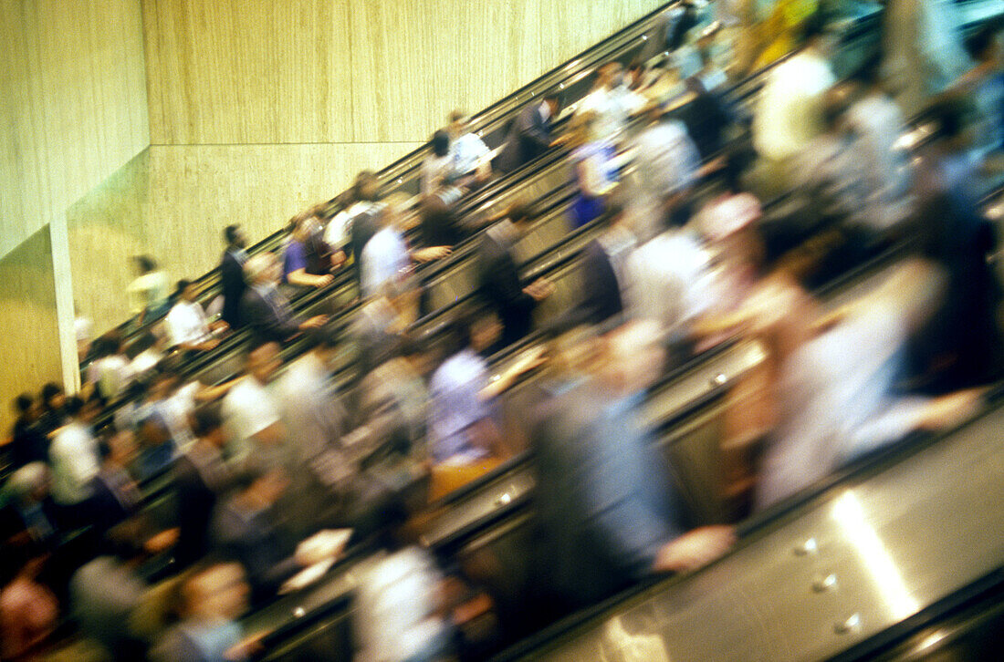 Commuters on escalators.