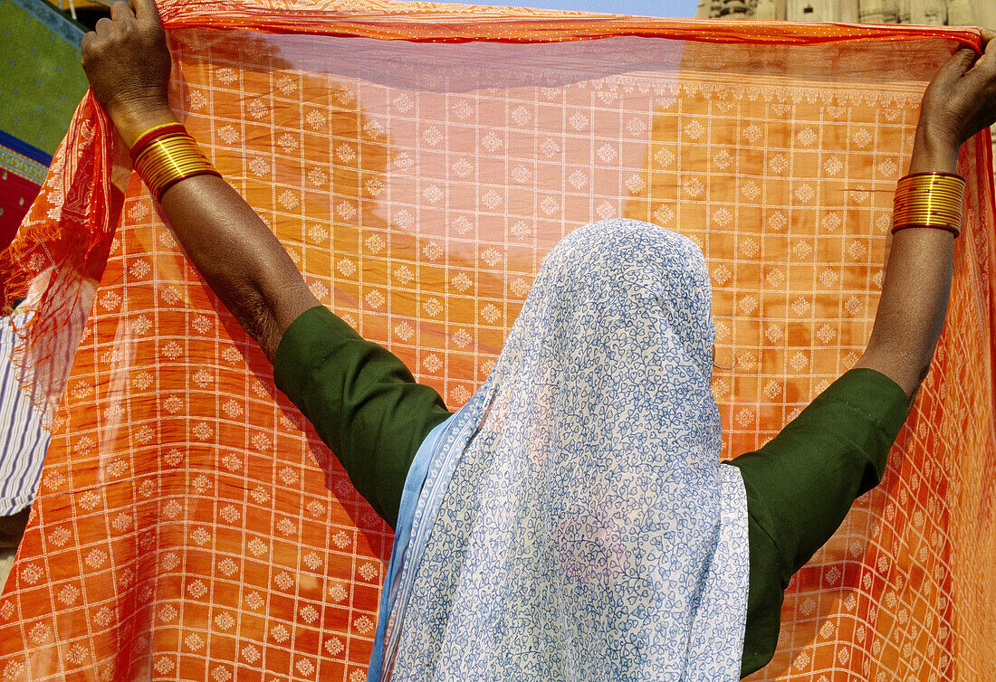 Indian woman drying a sari in the air, Varanasi. Uttar Pradesh, India