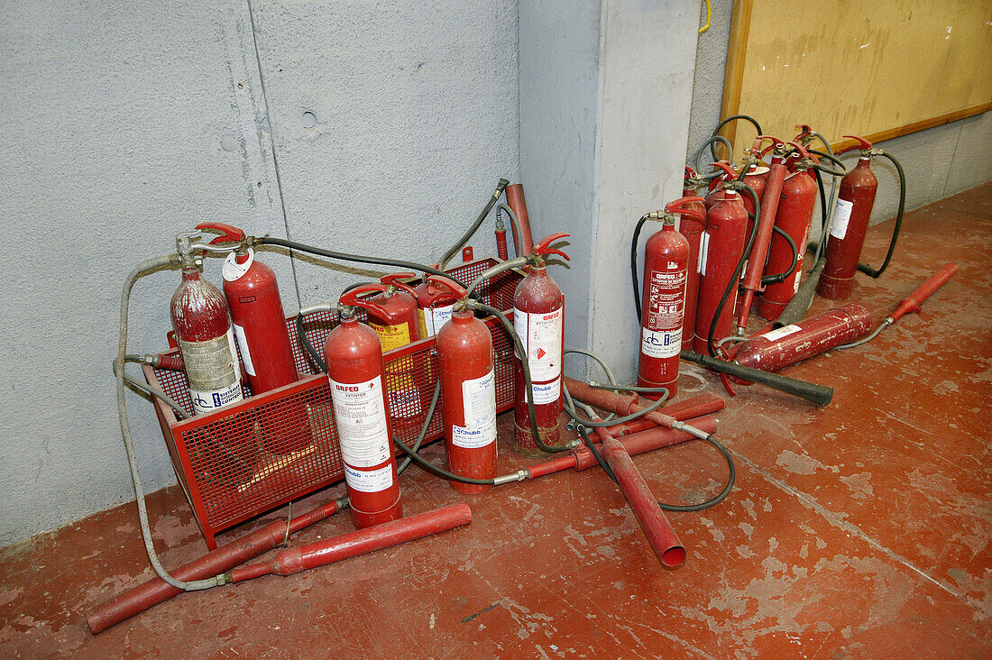 Several fire extinguishers in the floor