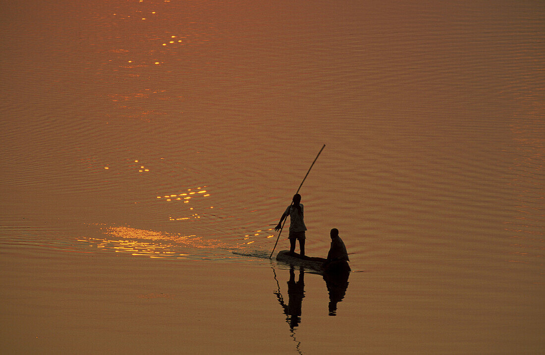 Fishermen at sunset on the Luangwa river. South Luangwa National Park, Zambia.