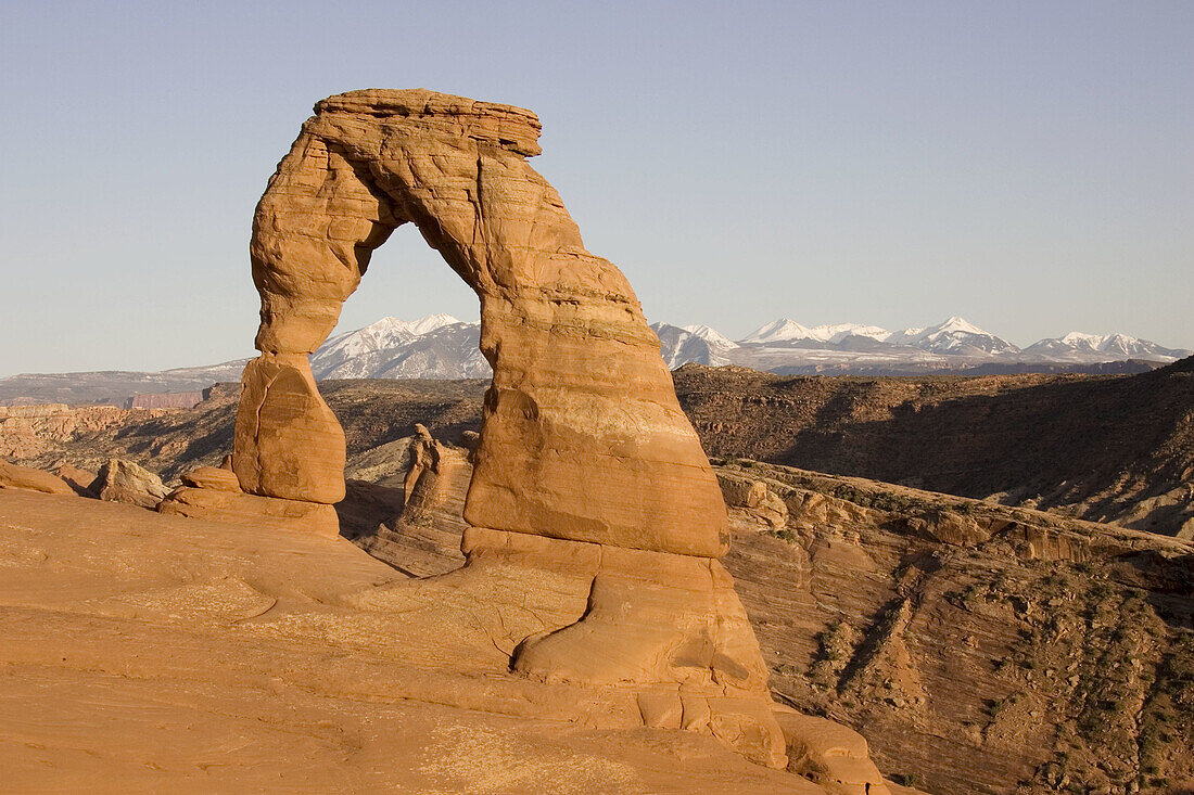 Delicate Arch probably is the most famous sandstone rock sculpture in the Arches National Park. In the background the snow-capped La Sal Mountains. Photographed in spring (April). Arches National Park, Utah, USA.