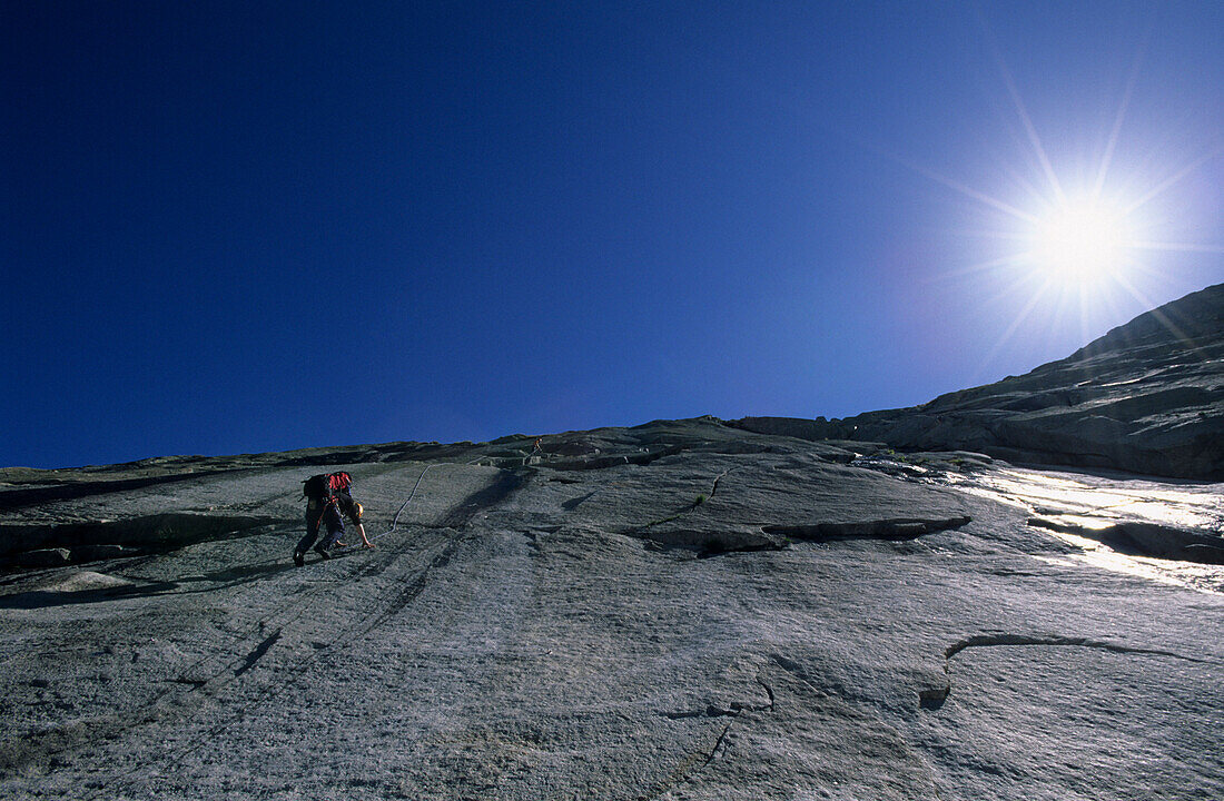Climber on granite slab, Klein Furkahorn, Urner Alps, Canton of Uri, Switzerland
