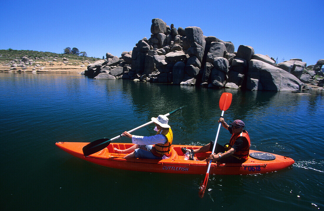 Two people kayaking on Lake Jindabyne at the foot of the Snowy Mountains, Kosciuszko National Park, New South Wales, Australia