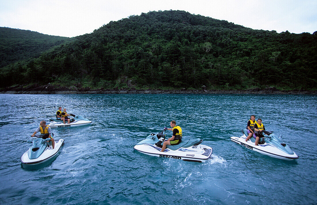 A group of people on a jet ski tour from Brampton Island. Carlisle Island in the background, Whitsunday Islands, Great Barrier Reef, Australia