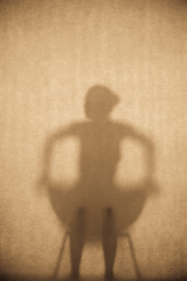 Shadow of a woman sitting on a chair