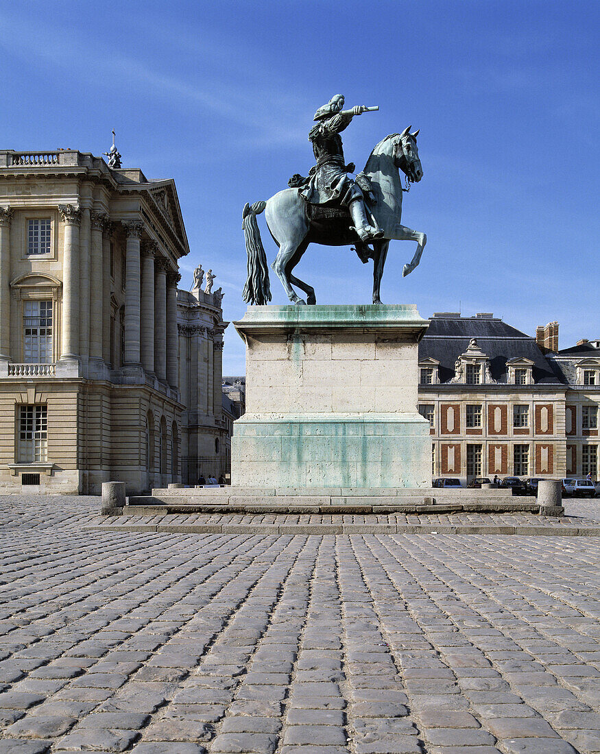 Equestrian statue of Louis XIV in front of palace. Versailles. France