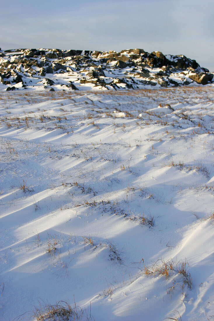 Frozen rocky outcropping near the coast of the town of Churchill, Manitoba, Canada.