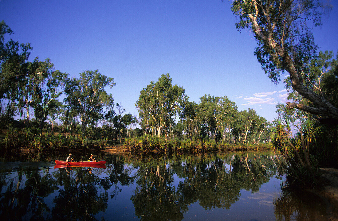 Two people canoeing on Miners Pool on the Drysdale River station, Western Australia, Australia