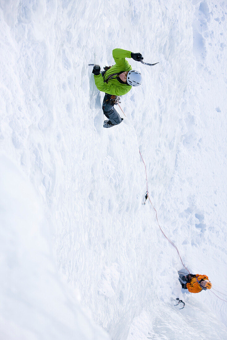 Two persons ice climbing at Corn Diavolezza (man-made icefall), Pontresina, Upper Engadin, Grisons, Switzerland