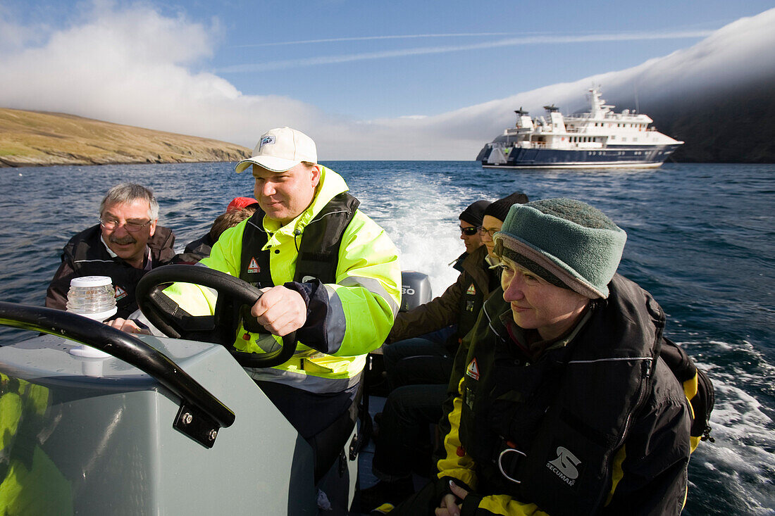 Touristen und ein Matrose auf einem Gummiboot, Zodiac, Hermaness, Insel Unst, Shetland Islands, Schottland, Großbritannien, MR nur  der Touristen, dunklen Jacken