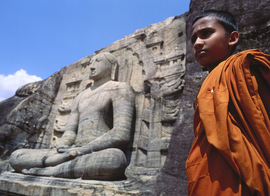 Buddhist child at Gal Vihara temple (built in the 12th century), Polonnaruwa. Sri Lanka