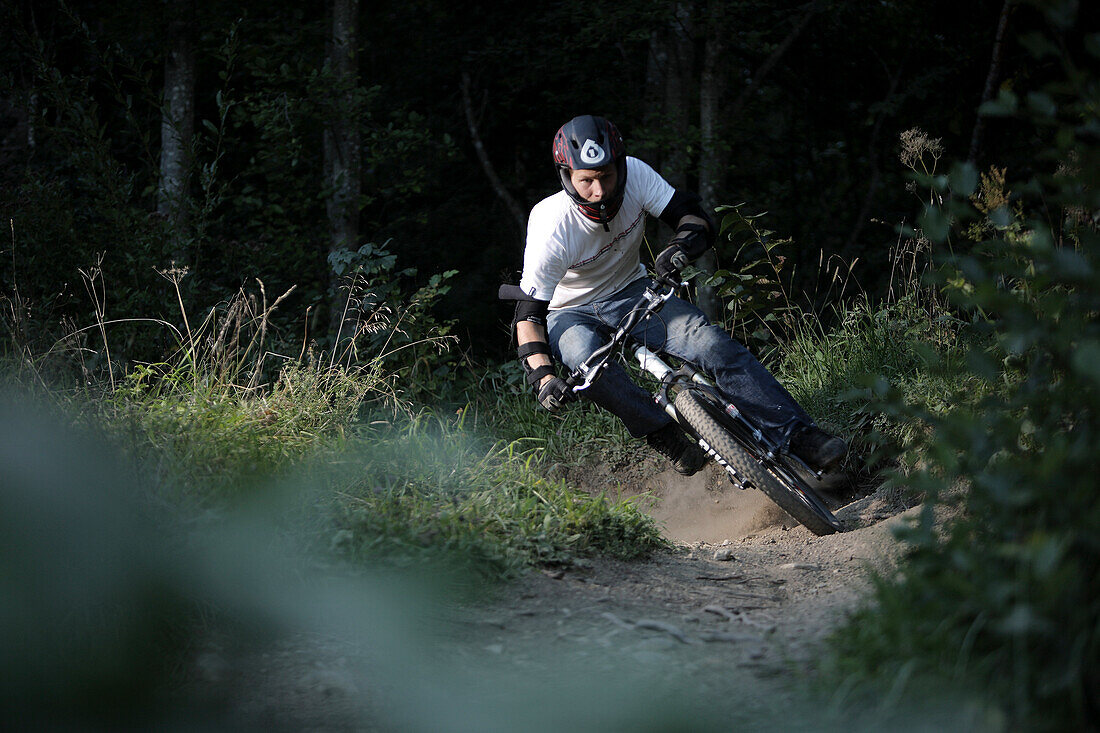 young man riding his mountainbike, Oberammergau, Bavaria, Germany