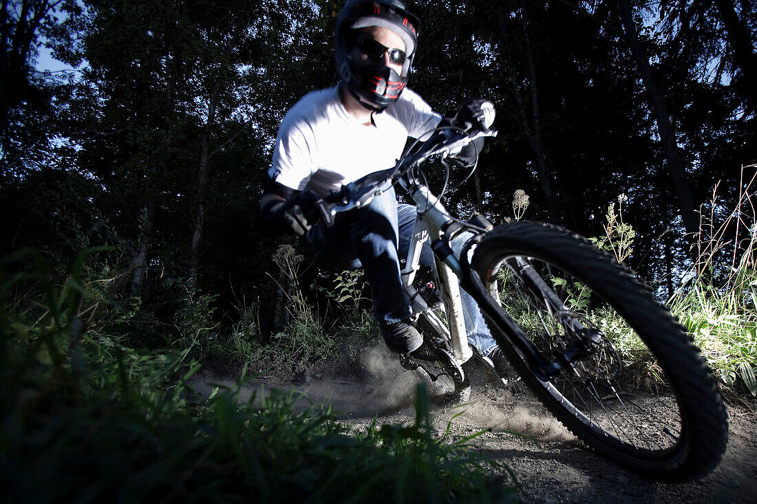 Mountain biker riding over forest track, Oberammergau, Bavaria, Germany