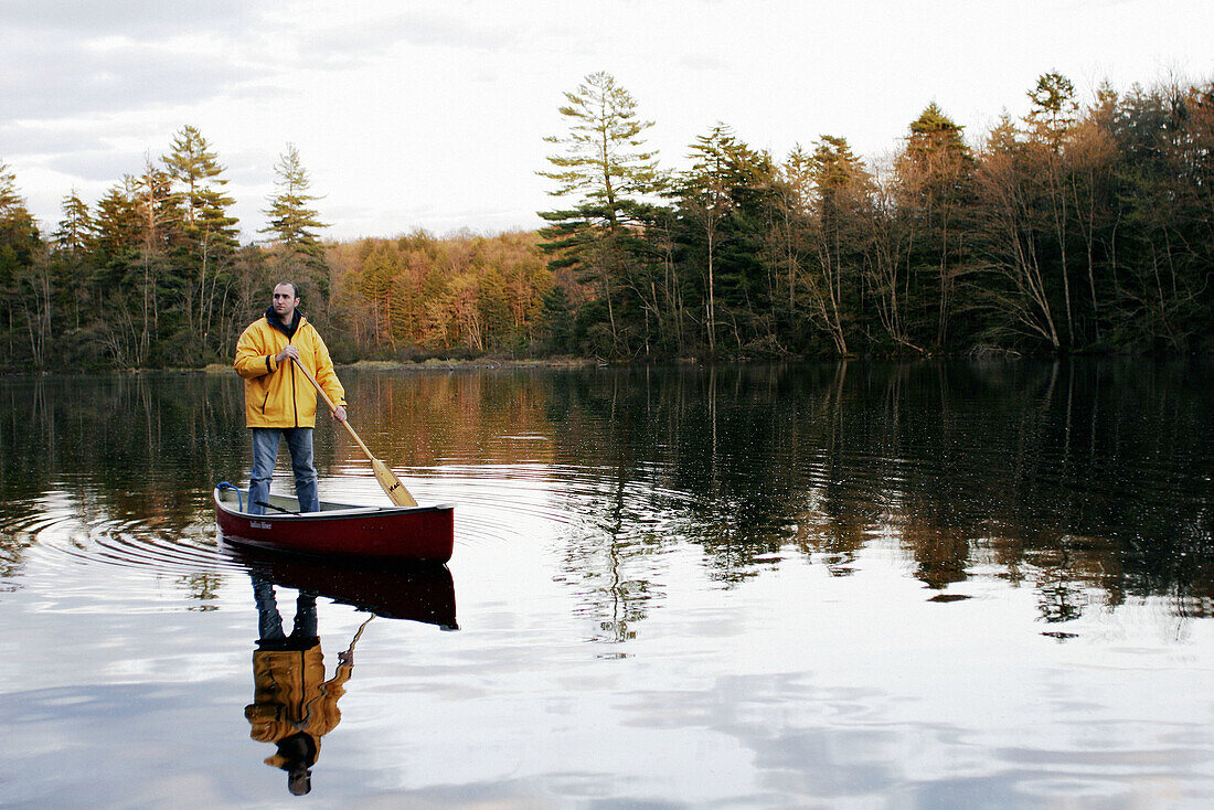 Man in canoe on mountain lake