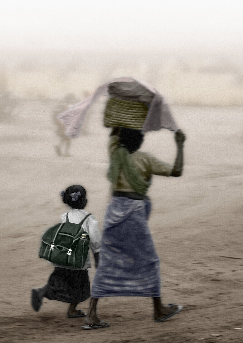 Mother and daughter going to school. India