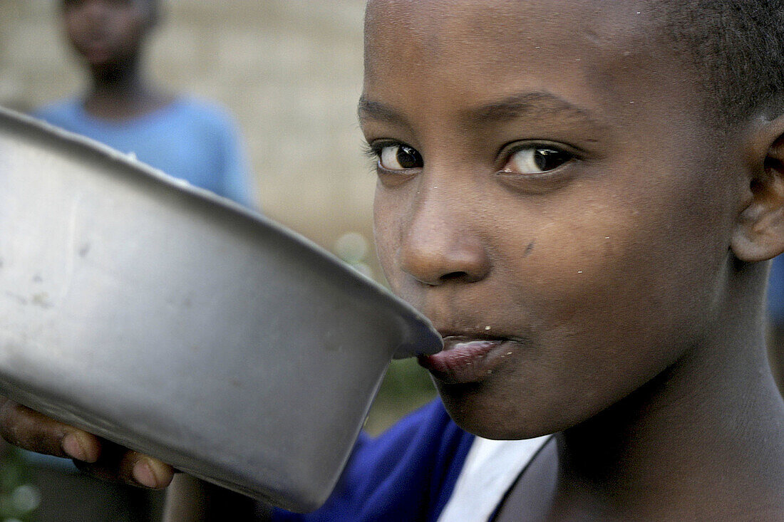 African girl eating. Tanzania.