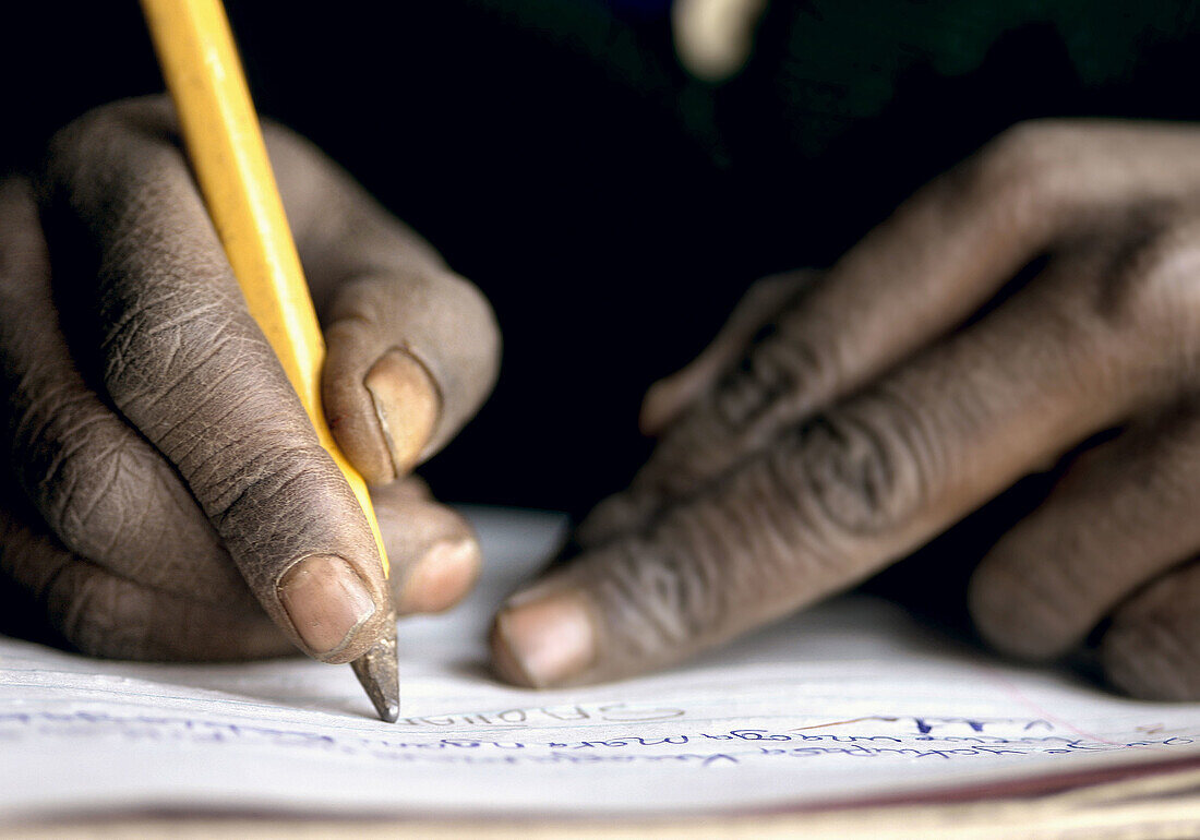 Boy at school writing. Tanzania
