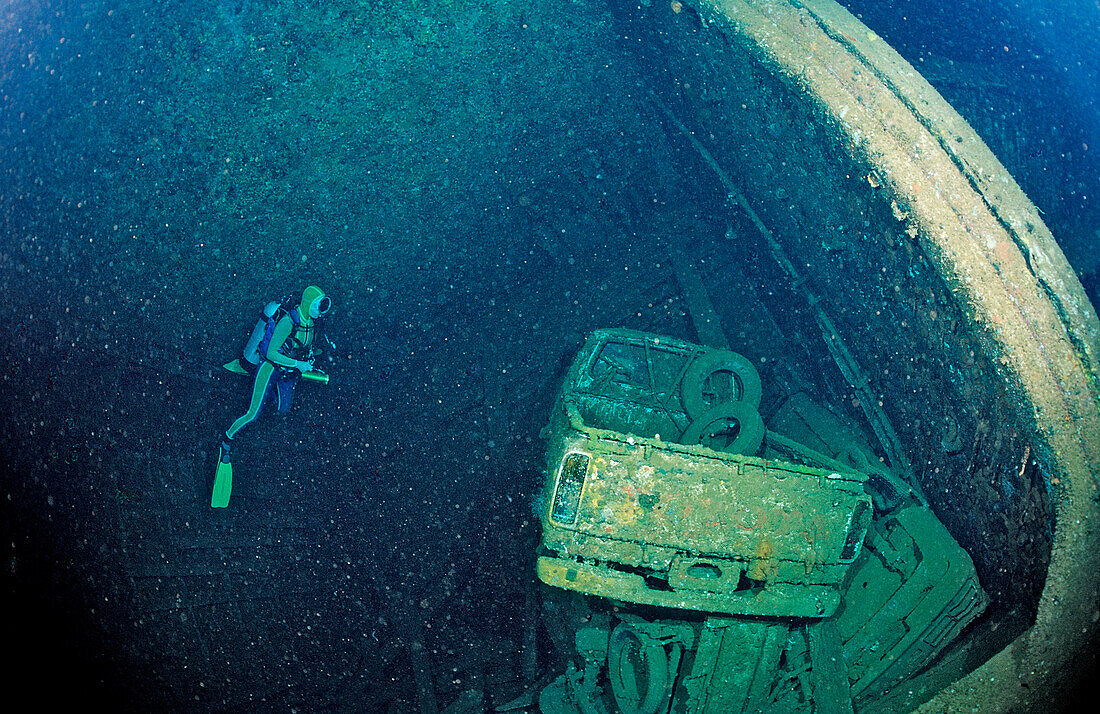 Scuba diver and Truck wreck in Blue Belt shipwreck, Sudan, Africa, Red Sea