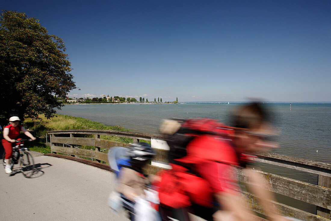 Two cyclists riding along Lake Constance, Arbon, Canton of Thurgau, Switzerland