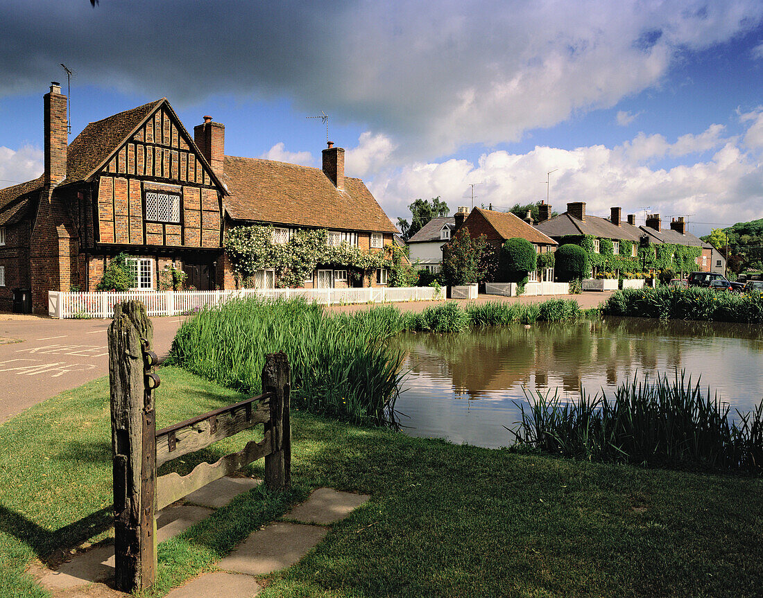 Manor house, church and pond. June. Aldbury. Hertfordshire. England. UK.