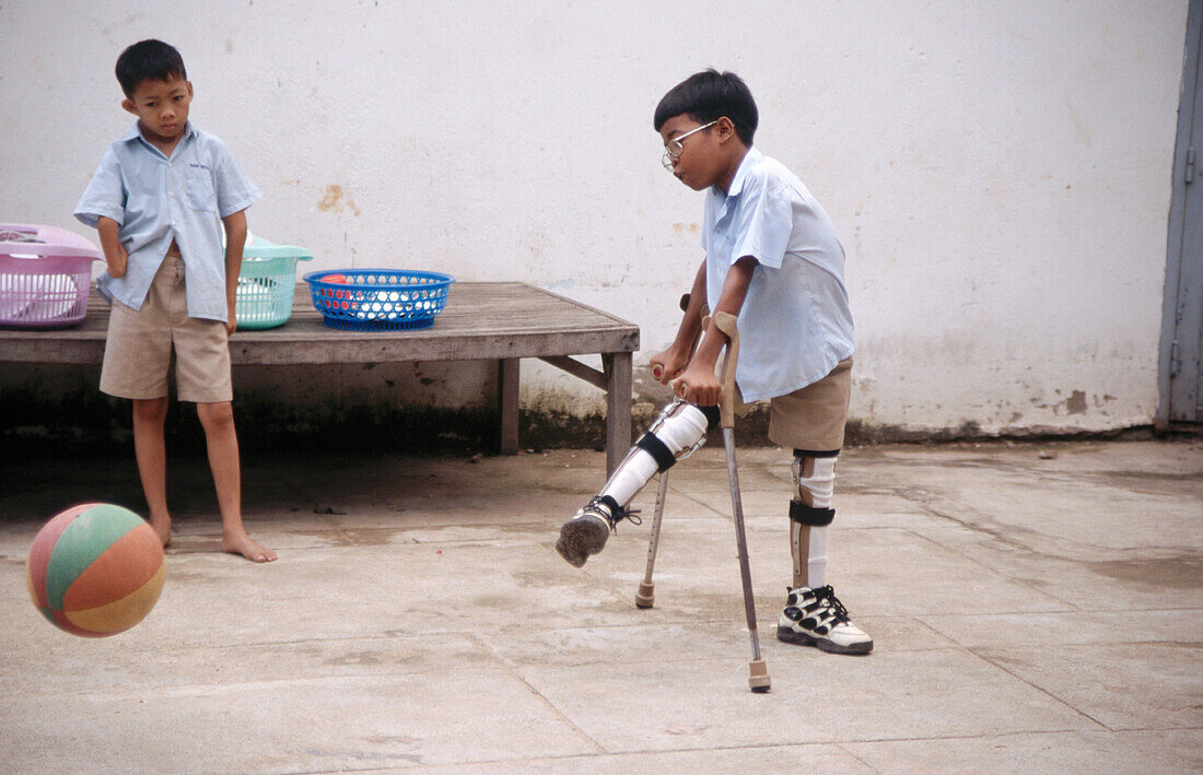 Disabled boy playing soccer. Phnom Penh. Cambodia