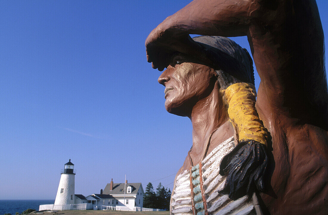 Native American statue and Pemaquid lighthouse. Pemaquid Point. Maine. USA