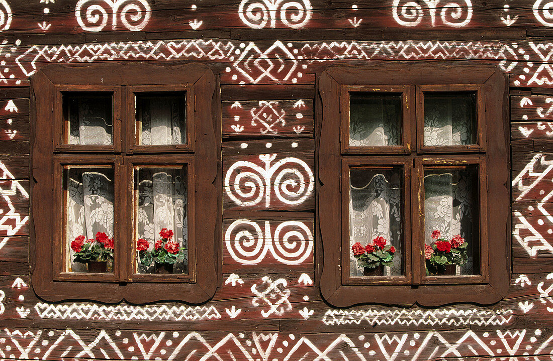 Wood cottages painted with embroidery motifs in Cicmany Village. Central Slovakia
