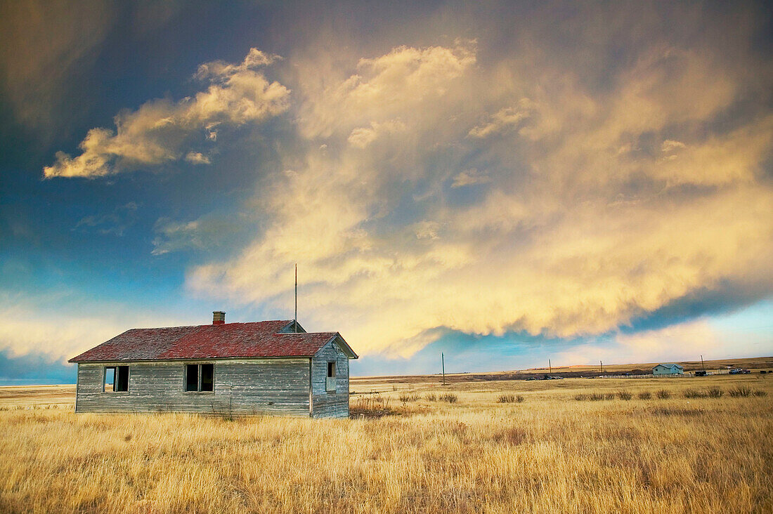 House, landscape with dramatic sky. Cardston. Alberta, Canada