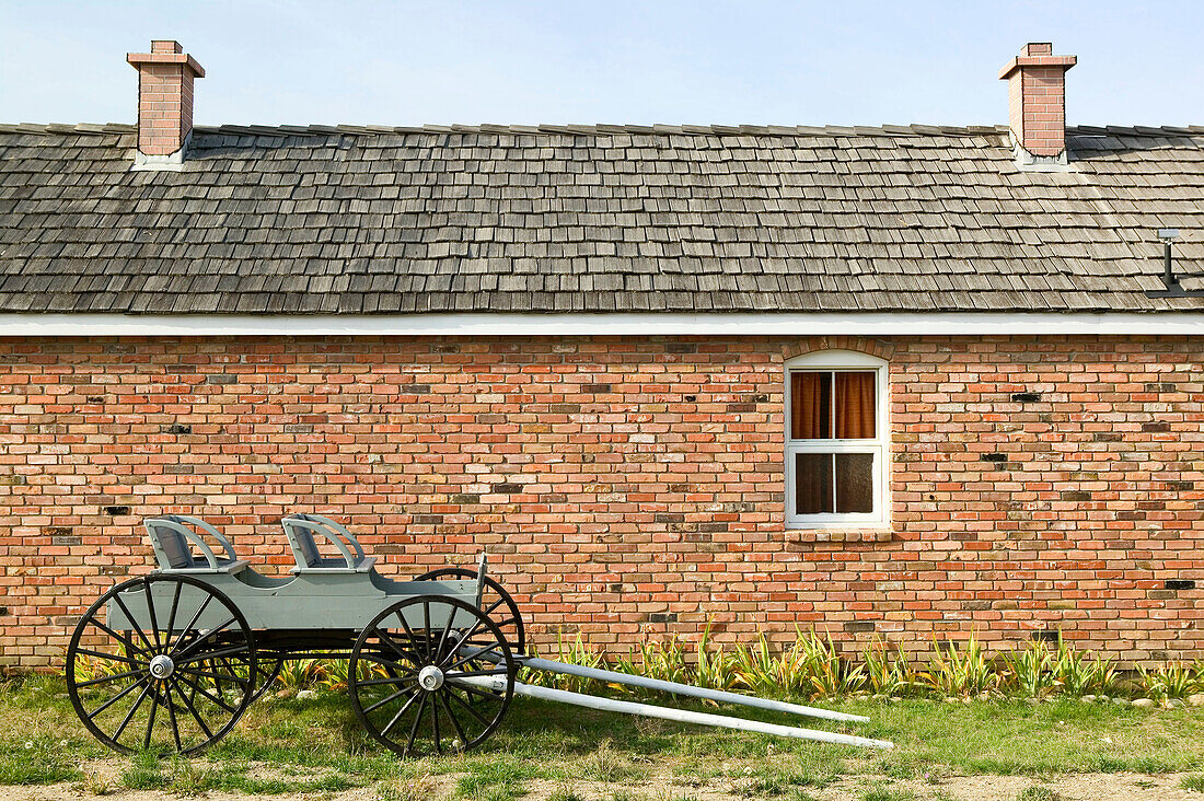 Russian pacifist Doukhobor Village Museum, brick house and buggy. Castlegar. British Columbia, Canada