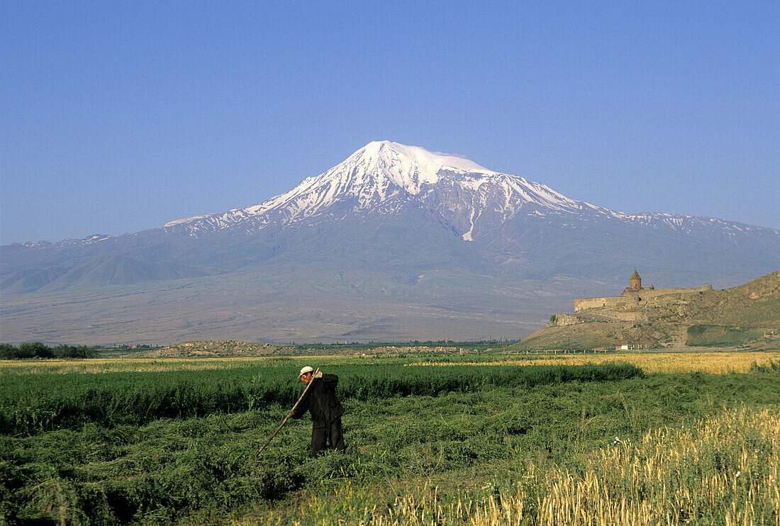 Fields, Khor Virap Monastery (16th century) and Mt. Ararat in background. Armenia