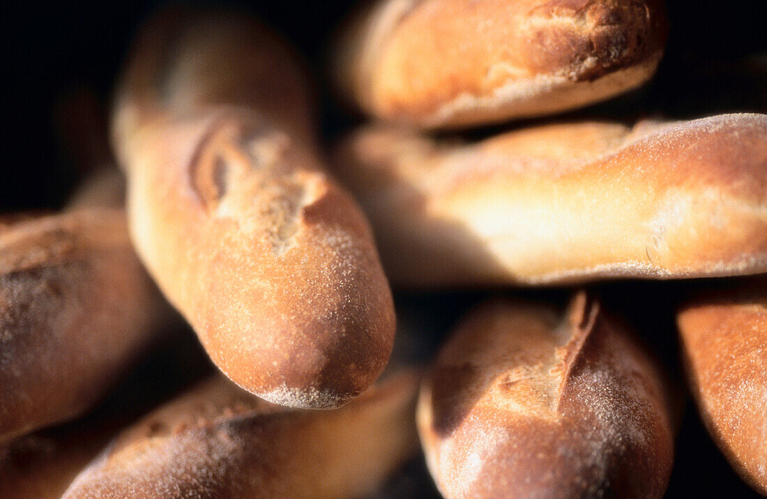 Assorted loaves of French bread pointing to the camera