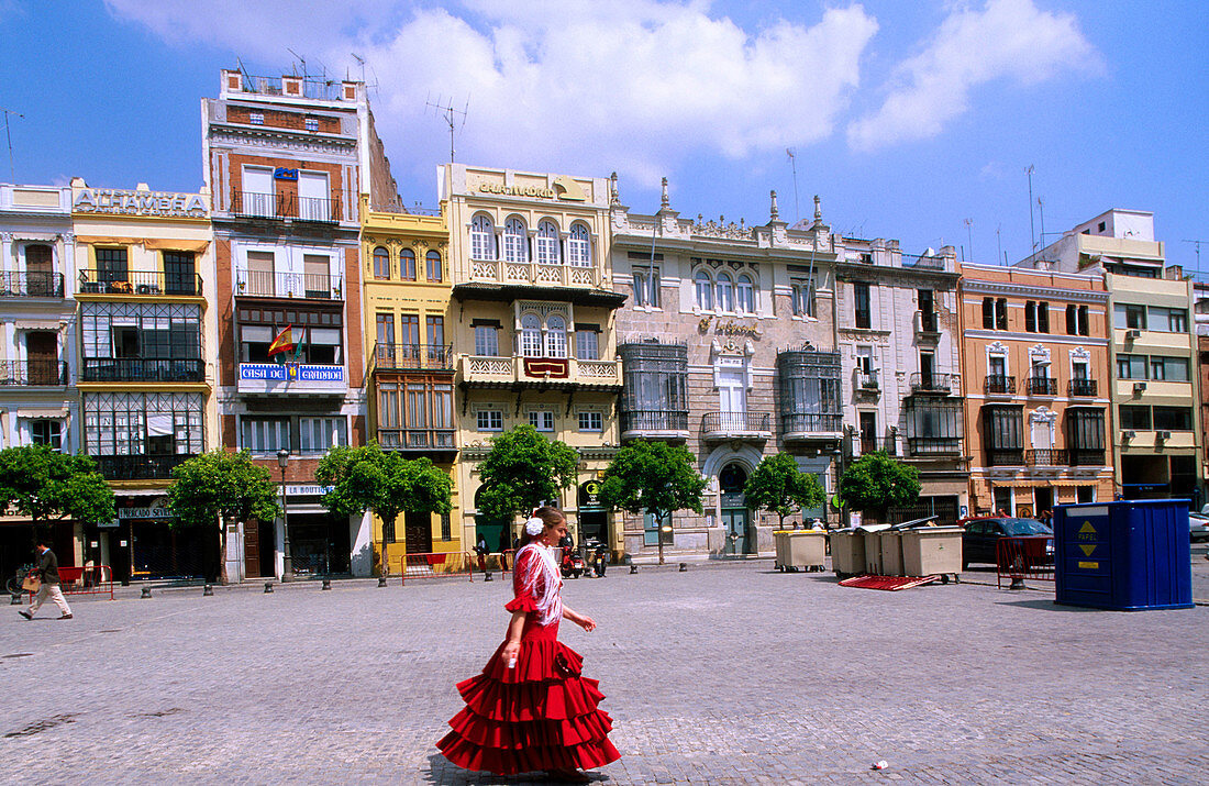 Woman wearing the traditional costume in San Francisco Square in Seville. Andalusia. Spain