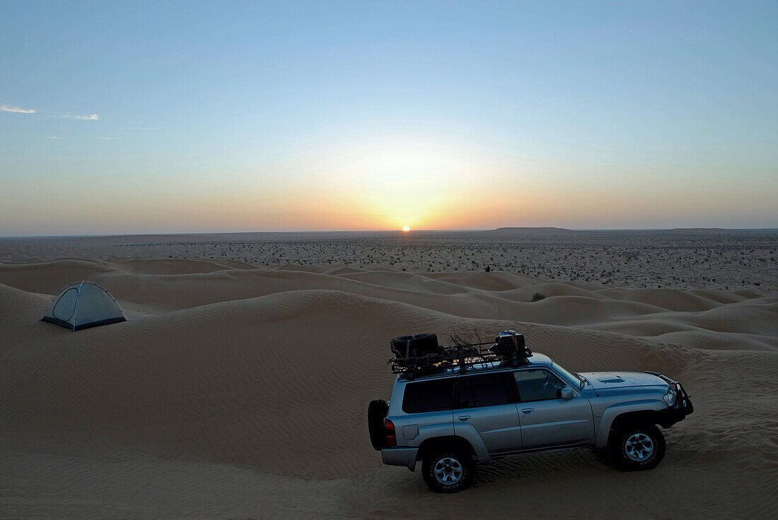 A 4x4 vehicle driving through sand dunes in the desert, 4x4 Sahara Desert Tour, Bebel Tembain area, Sahara, Tunisia, Africa, mr