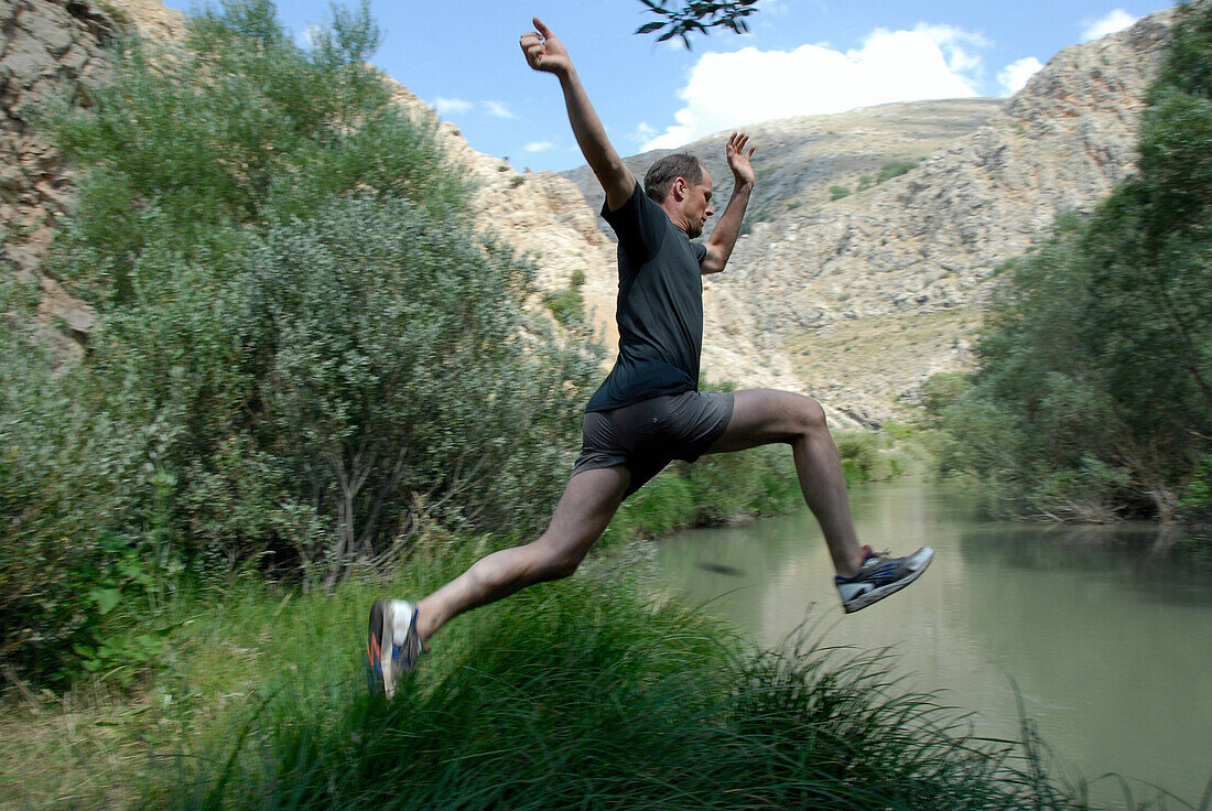 Man jumping into water, between Kozluca and Tashan, Highlands of Zamanti, Taurus Mountains, Turkey, Europe