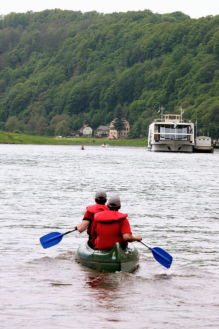 Two people kayaking on river Elbe between Rathen and Dresden, Saxony, Germany