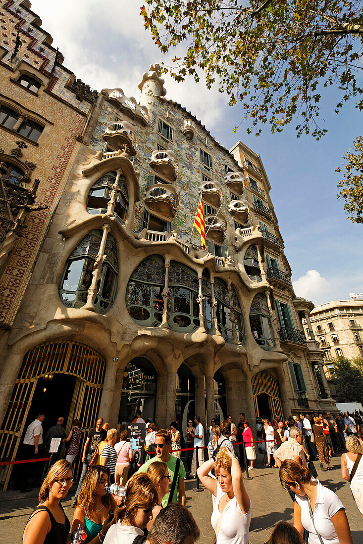 Barcelona,Passeig de Gracia,Casa Batllo by Antonio Gaudi,visitors qeeing in front