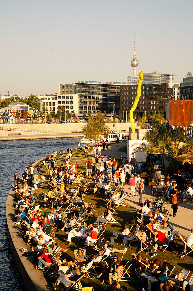 Berlin capital beach near Lehrter main station, riverbank Spree , Tour boat people