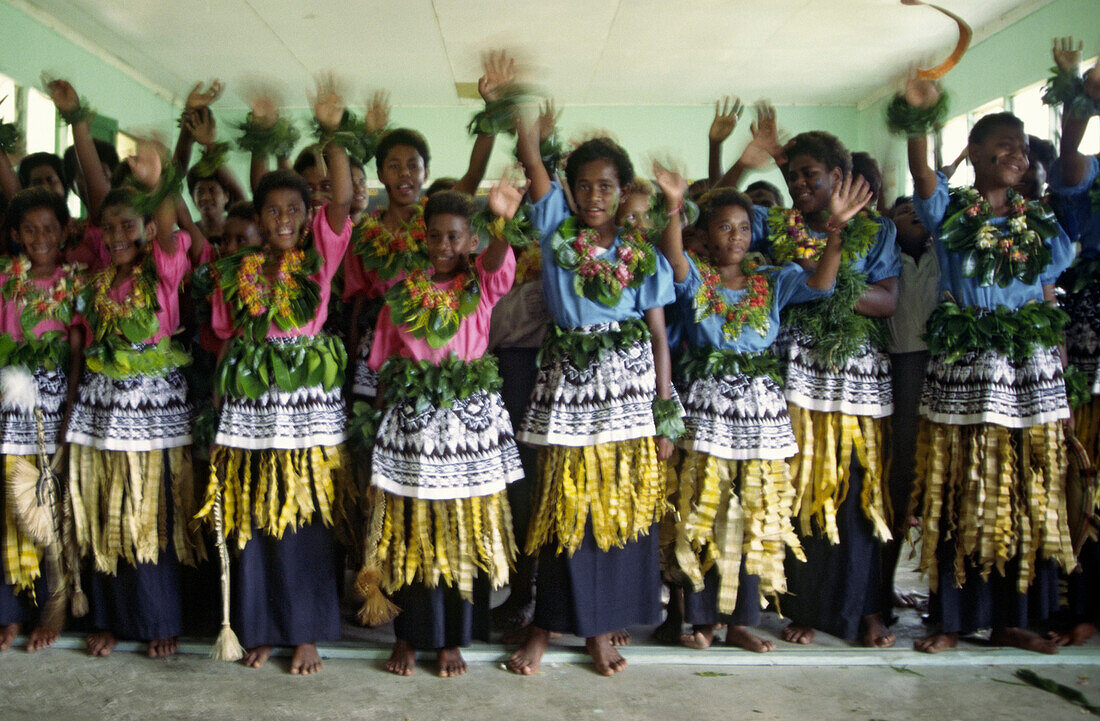 south pacific  Fiji Vitu Levu Nananu I Ra Island school class, children waving with their hands