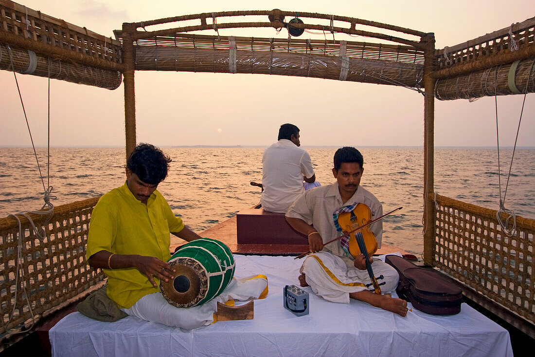 India Kerala house boat in backwater lake indina musicians at sunset tour