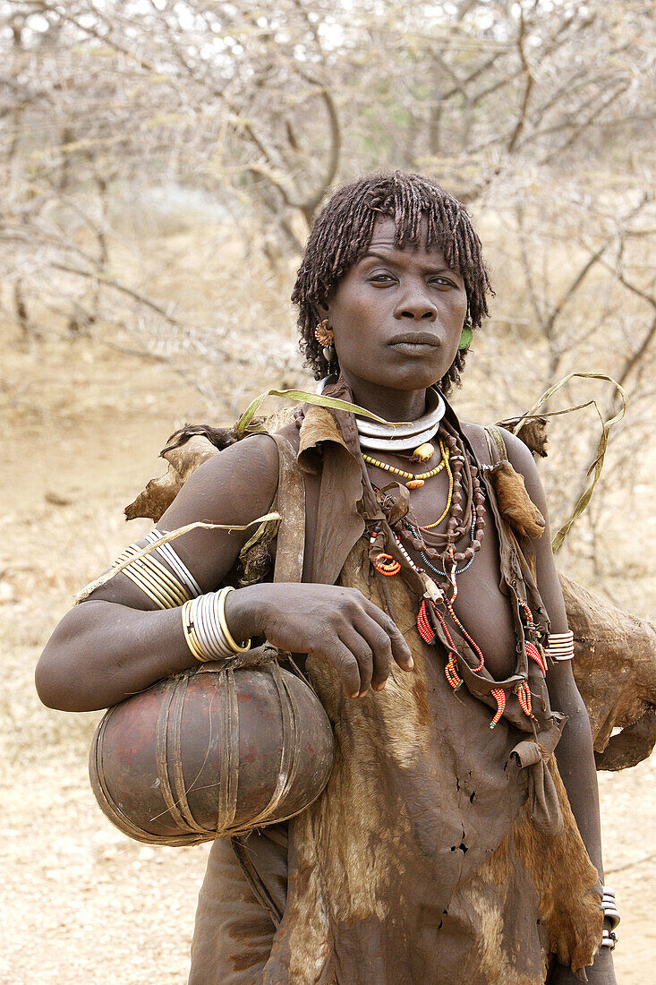 Woman Hamer tribe. Lower basin of Omo river. Copper skin with very fine features and wear metal arm and leg bracelets, shells and beads. South Ethiopia.